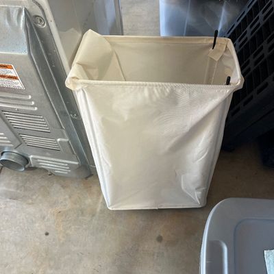 Sale Photo Thumbnail #115: A cream-colored fabric laundry hamper with a lightweight, collapsible frame.