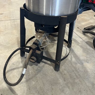 Sale Photo Thumbnail #29: Outdoor propane burner stand with a large stainless steel pot, showing light wear from use.