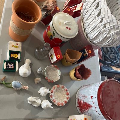 Sale Photo Thumbnail #36: Assortment of tabletop decor and holiday items including terracotta planters, small porcelain animal figurines, Hallmark ornament boxes, and a large Christmas tin.