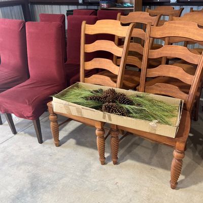 Sale Photo Thumbnail #88: Set of ladder-back wooden dining chairs paired with chairs in red fabric slipcovers, alongside a long wooden bench with barley twist legs.