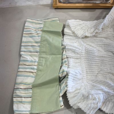 Sale Photo Thumbnail #63: Folded pastel striped window valance with sage green trim alongside a white textured plush blanket.