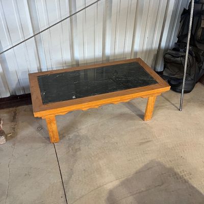 Sale Photo Thumbnail #82: Low wooden coffee table featuring a dark green slate or faux-marble inlay and scalloped apron detailing.