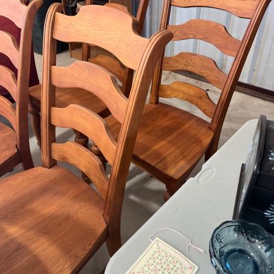 Sale Photo Thumbnail #8: Set of light oak ladder-back dining chairs with contoured wooden seats, showing minimal wear.