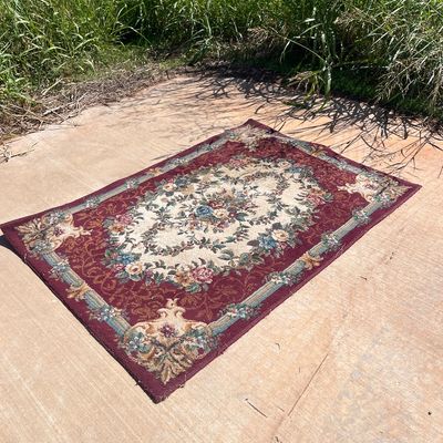 Sale Photo Thumbnail #113: Traditional floral area rug with a burgundy border and cream central medallion.