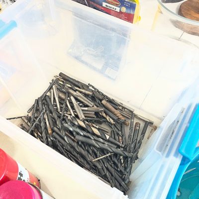 Sale Photo Thumbnail #21: Large collection of assorted drill bits and taps stored inside a clear plastic storage container.