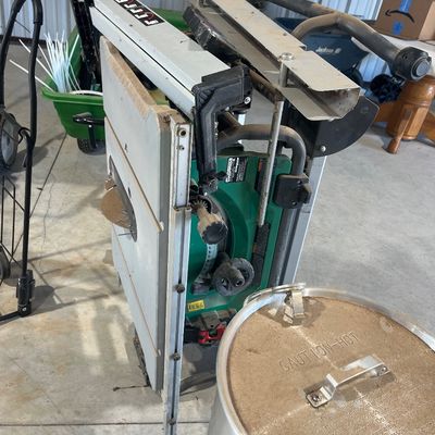 Sale Photo Thumbnail #87: Portable Ryobi 10-inch table saw with folding stand, showing signs of light workshop use, positioned next to a outdoor turkey fryer pot.