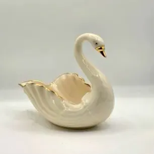 Vintage Lenox-style ivory ceramic swan trinket dish, featuring iridescent glaze and gilded accents on the beak and rim.