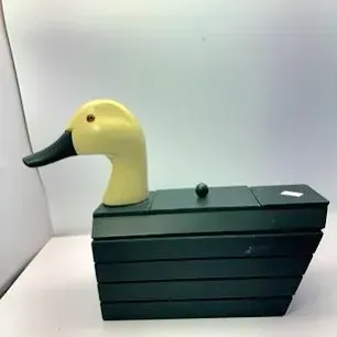 Novelty wooden duck-shaped storage box featuring a carved cream-colored duck head with glass eye and a dark green slatted body with a...