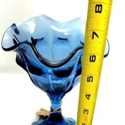 Cobalt blue glass footed dish with a ruffled rim, measuring approximately 7.5 inches tall.