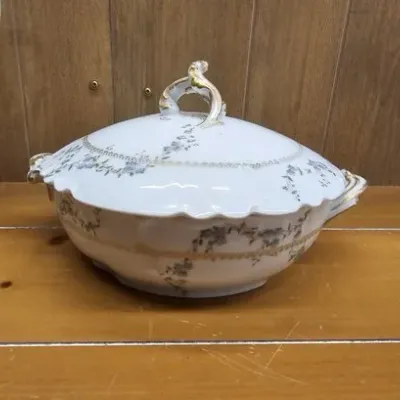 Antique Limoges porcelain covered tureen featuring delicate blue floral sprigs, raised beaded accents, and gilded handles.