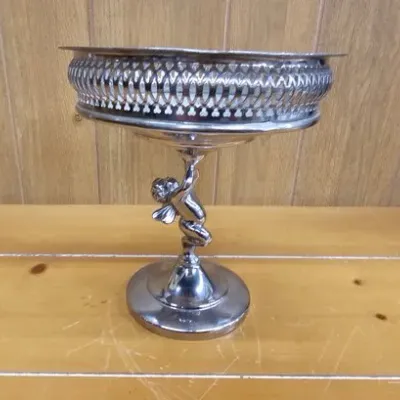 Silver-plated pedestal compote bowl featuring a cherub or angel stem and reticulated pierced gallery rim.