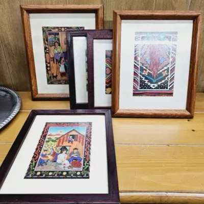 Collection of framed southwestern and folk art prints, presented in dark wood and oak frames.