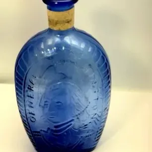 Cobalt blue glass historical portrait flask featuring an embossed profile bust of General Washington, complete with a cork stopper.
