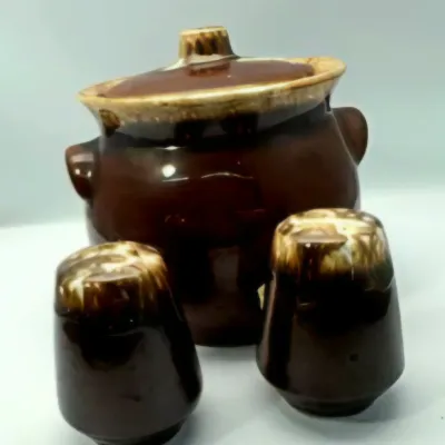 Vintage Hull pottery brown drip glazed sugar bowl or bean pot with matching salt and pepper shakers.