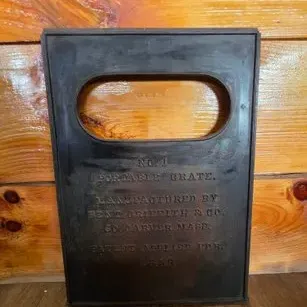 Antique cast iron portable grate plate manufactured by Benj. Griffith & Co. in So. Carver, Mass., featuring raised lettering and an...