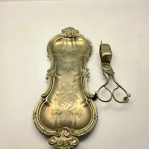 Vintage silver-plated candle snuffer and ornate tray set featuring intricate scrollwork and engravings.