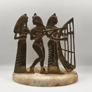 Vintage Egyptian Revival brass statuette featuring female musicians mounted on a round marble or alabaster base.