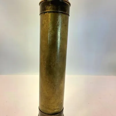 Antique brass spyglass kaleidoscope featuring an aged, patinated finish and dark metal accents.