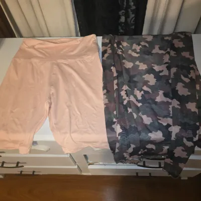 Sale Photo Thumbnail #105: Bulk lot of women's apparel featuring a variety of styles, colors, and patterns. Included are colorful crochet/knit striped pants with drawstring, black denim overalls (No Boundaries, NWT), a ribbed long-sleeve top, a knit sweater vest, black tops, a stri