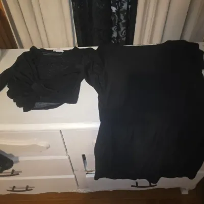 Sale Photo Thumbnail #101: Bulk lot of women's apparel featuring a variety of styles, colors, and patterns. Included are colorful crochet/knit striped pants with drawstring, black denim overalls (No Boundaries, NWT), a ribbed long-sleeve top, a knit sweater vest, black tops, a stri