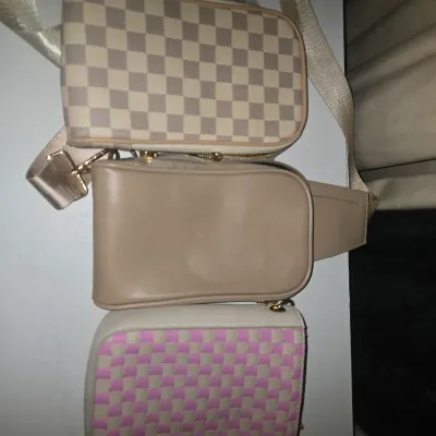 Sale Photo Thumbnail #91: Set of three compact crossbody/sling bags in various designs, including a neutral checkerboard pattern, a solid beige/taupe finish, and a pink and white woven checkerboard style. Features zippered closures and adjustable shoulder straps. Items show light 