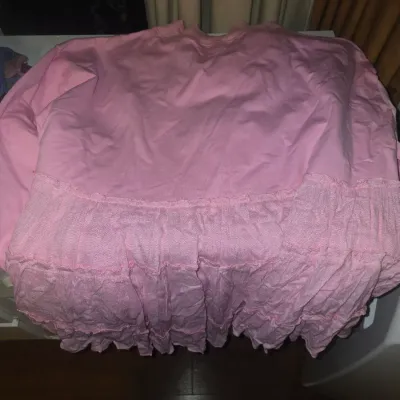 Sale Photo Thumbnail #81: Assorted lot of women's apparel including tank tops, cropped tops, knit sweater vests (including checkered patterns and 'miss love' brand), a pink tiered ruffle top, a white lace-trimmed bodysuit, a gold crop top, and knit socks. Items are lightly used to