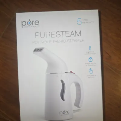 Sale Photo Thumbnail #47: Pure Enrichment PureSteam handheld portable fabric steamer. Features include auto safety shut-off, fast heat-up time, and compact design. Comes in original box packaging.