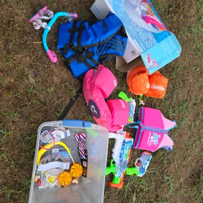 Sale Photo Thumbnail #153: Large collection of outdoor pool and water recreation gear. Includes an Intex Mega Pegasus inflatable island float in original box, multiple youth life vests and Stearns Puddle Jumpers, U.S. Divers snorkel set and various goggles, X-Shot water squirt guns