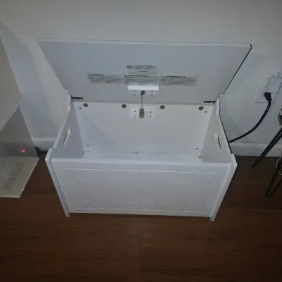 Sale Photo Thumbnail #37: White painted wooden toy box / storage bench featuring beadboard-style front panel detail, side handles, and a safety hinge soft-close lid mechanism. Appears in good pre-owned condition with light cosmetic wear consistent with use.