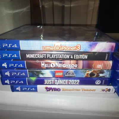 Sale Photo Thumbnail #61: A stack of 6 PlayStation 4 (PS4) video game titles in original cases. Includes LittleBigPlanet 3,Minecraft PlayStation 4 Edition, Hello Neighbor, LEGO Jurassic World, Just Dance 2022, and Spyro Reignited Trilogy. All items show light shelf wear on the cas