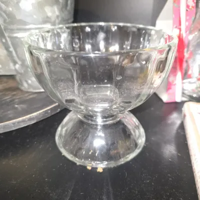 Sale Photo Thumbnail #25: Clear molded glass footed dessert/ice cream sundae bowl featuring a paneled design. In good condition with light dust and surface wear consistent with age and use; no visible chips or cracks seen.