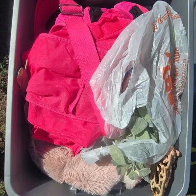 Sale Photo Thumbnail #121: Storage tote filled with an assortment of craft supplies, fabrics, and decor items. Includes a plastic storage tote, pink canvas bag/apron, faux fur fabric, green textured woven fabric, blue satin-like fabric, black/white woven textile, decorative butterf