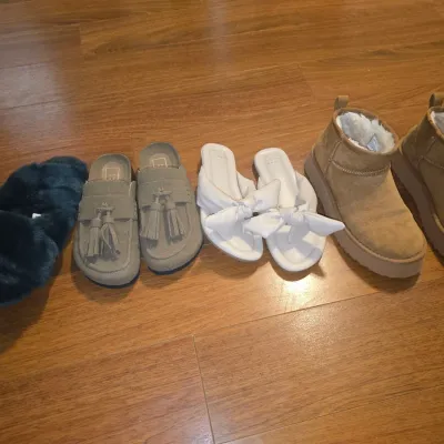 Sale Photo Thumbnail #40: Collection of four pairs of women's shoes and footwear including tan faux-fur lined platform mini boots, white bow sandals (A New Day), grey tassel mule loafers (Universal Thread), and dark fluffy slippers. Items show light pre-owned wear with clean soles