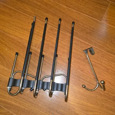 Sale Photo Thumbnail #195: Includes multi-tier space-saving metal and plastic pants hangers/organizers and a metal over-the-door double hook. Appears in good, usable condition with light signs of wear.
