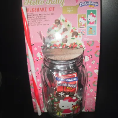 Sale Photo Thumbnail #26: Unopened Hello Kitty Milkshake Kit packaged with a decorated glass mason jar, red and white striped straw, strawberry milkshake mix, sprinkles, mini marshmallows, and Cookie Dough Bites. Theme features Hello Kitty in holiday attire. Unopened in original p