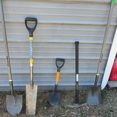 Sale Photo Thumbnail #127: Set of 5 long and short-handled garden and landscaping tools. Includes two Blue Hawk shovels (round point and transfer shovel), a Vulcan trenching shovel with D-handle, a mini D-handle shovel, and a pickaxe/mattock with a fiberglass handle. All items show