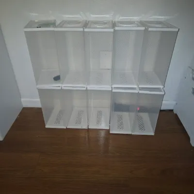 Sale Photo Thumbnail #35: Group of 10 stackable clear plastic shoe storage boxes with white frames and drop-front door openings. Ideal for organizing footwear, accessories, or small items. Items show light wear consistent with gentle use.
