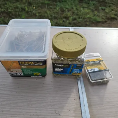 Sale Photo Thumbnail #167: An assortment of exterior wood and deck screws in plastic containers. Includes:
- Deck Plus Tan Wood & Fence Screws (10 x 2-1/2 in)
- PowerPro Premium Wood Screws (10 x 3-1/2 in, approx. 60 pcs)
- Hillman Exterior Construction Screws (8 x 1-1/2 in)

Conta