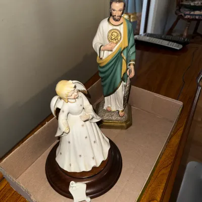 Sale Photo Thumbnail #272: Pair of vintage religious figurines, including a kneeling porcelain angel mounted on a wooden base and a hand-painted statue of Saint Jude.