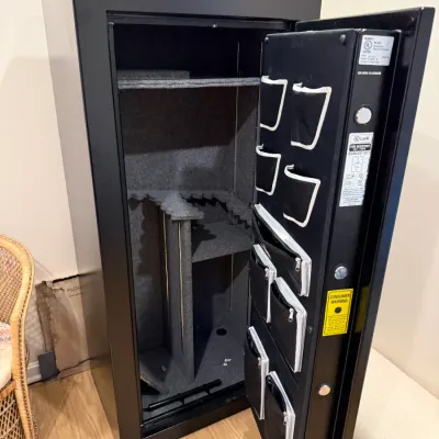 Sale Photo Thumbnail #369: Large black gun safe with carpet-lined interior shelving, gun racks, and door organizer pouches.