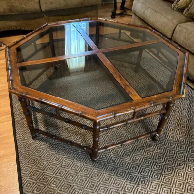 Sale Photo Thumbnail #316: Octagonal faux bamboo and glass-top coffee table in a dark wood finish, late 20th century.
