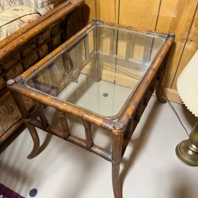 Sale Photo Thumbnail #405: Vintage bamboo and rattan side table featuring a glass insert top and cabriole-style legs.