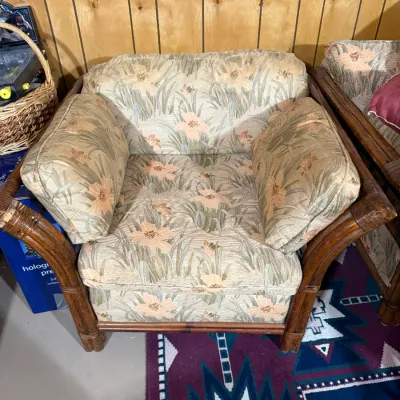 Sale Photo Thumbnail #402: Vintage bentwood and rattan armchair featuring a light floral pattern fabric upholstery with oversized arm cushions.
