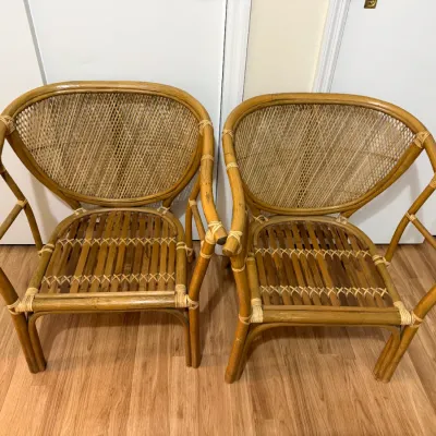 Sale Photo Thumbnail #133: Pair of vintage rattan barrel armchairs with woven cane backs and bamboo slat seats, circa late 20th century.