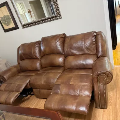 Sale Photo Thumbnail #8: Contemporary brown leather reclining three-seat sofa with brass nailhead trim detail along the rolled armrests.