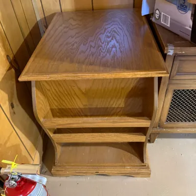 Sale Photo Thumbnail #389: Vintage oak magazine rack end table featuring a smooth top surface and multi-tiered open storage slots.