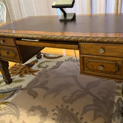 Sale Photo Thumbnail #54: Traditional wooden executive desk featuring a dark leather inlaid top, rope-twist trim, carved accents, and pull-out keyboard tray.