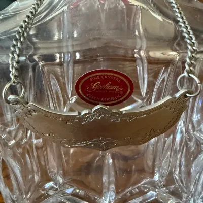 Sale Photo Thumbnail #332: Gorham cut crystal decanter featuring a original red foil maker's sticker and a silver-tone liquor label on a chain.