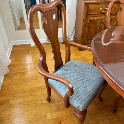 Sale Photo Thumbnail #222: Traditional Queen Anne style armchair with a carved vasiform splat, cabriole front legs, and blue pattern upholstered seat.