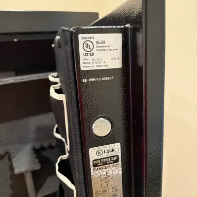 Sale Photo Thumbnail #372: Detail view of the door jam and certification stickers on a Ranger Deluxe fire-resistant residential security safe.